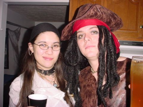 1995 Ford Probe - Two individuals are posing for a photo while dressed in pirate costumes, holding drinks.