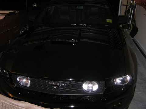 2007 Ford Mustang - Front view of a black 2007 Ford Mustang parked indoors.