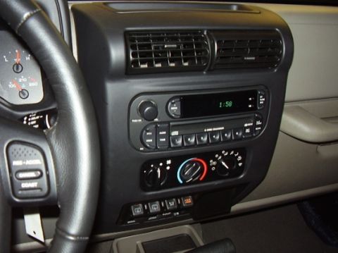 2000 Jeep TJ - Close-up of the dashboard and center console of a Jeep Wrangler, showing the radio and climate controls.