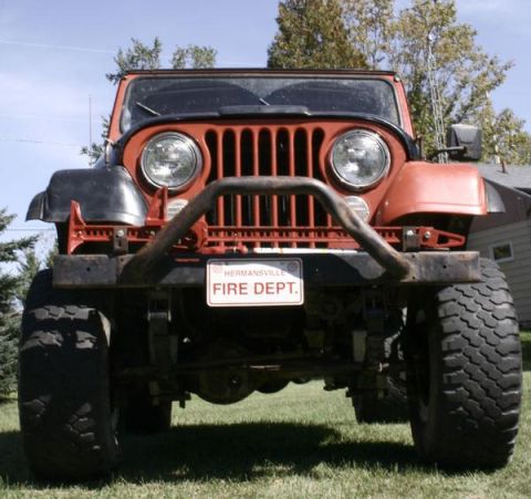 1979 Jeep CJ5 - Front view of an orange Jeep CJ5 with a "FIRE DEPT." license plate.