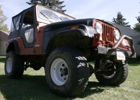 1979 Jeep CJ5 - This Jeep CJ5 features a two-tone red and black paint scheme and a soft top, with a "FIRE DEPT" plate on the front bumper.