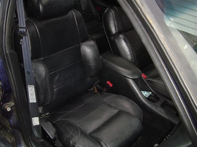 Black leather car seats and center console with a Supermotors.net watermark