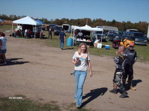 1995 Ford Probe - People gather at an outdoor event with tents and various vehicles present.