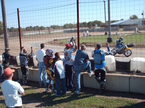 1995 Ford Probe - Spectators cheer on a rider during a dirt bike race event.
