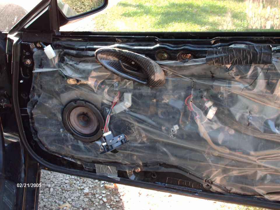Car door interior with speaker removed and carbon fiber handle