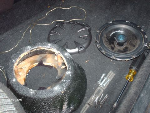 1995 Ford Probe - Car audio parts including a speaker and enclosure are laid out on a carpeted surface.