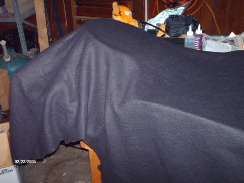 1995 Ford Probe - A custom speaker enclosure is covered in dark fabric, suggesting it is part of an automotive interior modification.