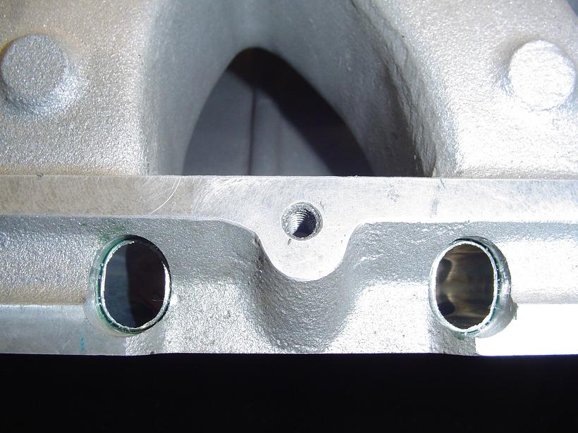 Close-up of an aluminum intake manifold with two ports visible