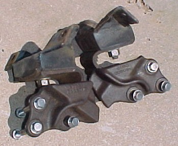 1965 Ford Mustang - Engine mounts are shown on a concrete surface.