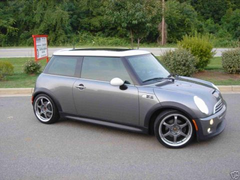 2003 MINI Cooper - This 2003 MINI Cooper features a distinctive gray body with a contrasting white roof and sunroof, captured in a three-quarter front view.
