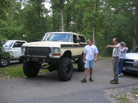 1992 Ford Mustang - A heavily modified 1978 Ford Bronco is parked on a paved surface with trees in the background.
