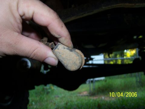 1979 Ford F-150 - A close-up shows a person holding a small, weathered rubber component with a metal attachment.