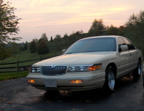 1996 Mercury Grand Marquis - Tan 1996 Mercury Grand Marquis parked outdoors during twilight.