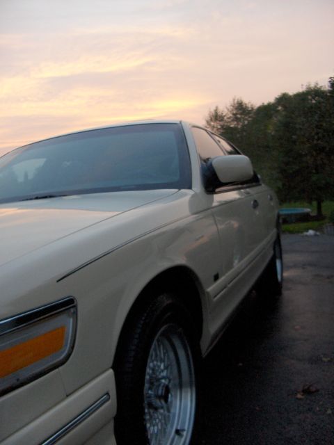 1996 Mercury Grand Marquis - A cream-colored 1996 Mercury Grand Marquis is shown from a 3q front angle at dusk.