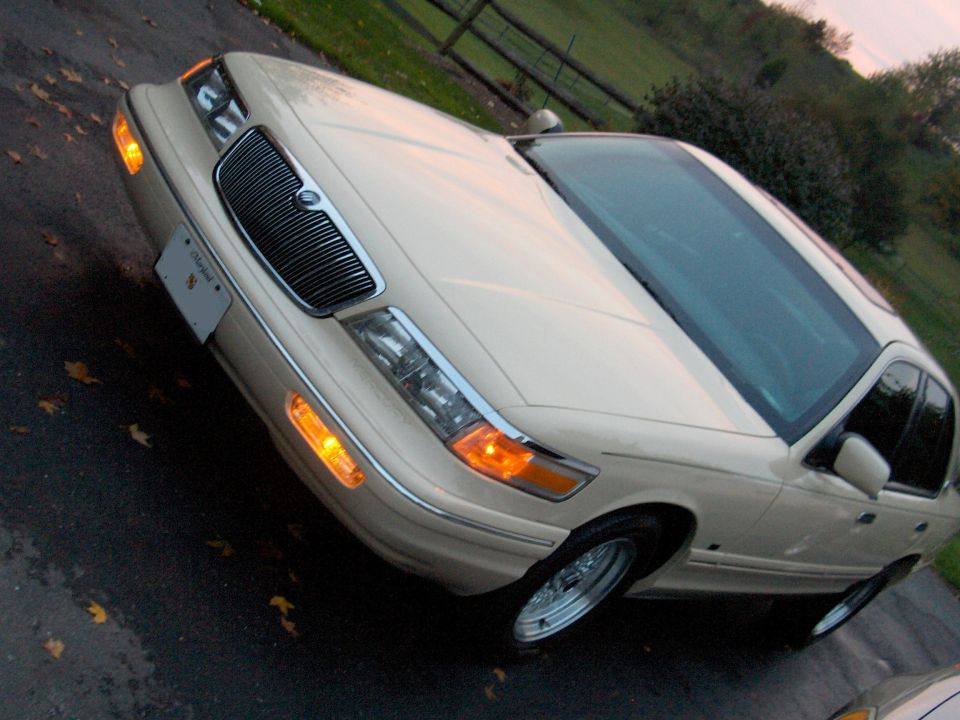 Cream-colored Mercury Grand Marquis sedan, front 3/4 view with chrome grille