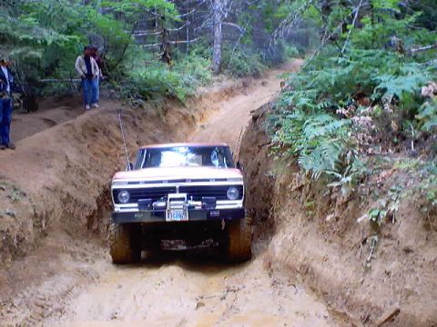 1976 Ford F-100 - Ford F-100 navigates a challenging muddy off-road trail.