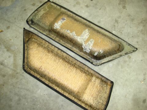 1974 Ford F-100 - These two door panels show significant wear and tear, with tan carpet and black trim.