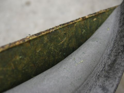 1974 Ford F-100 - A close-up view of a worn interior trim panel, showing its layered construction and texture.