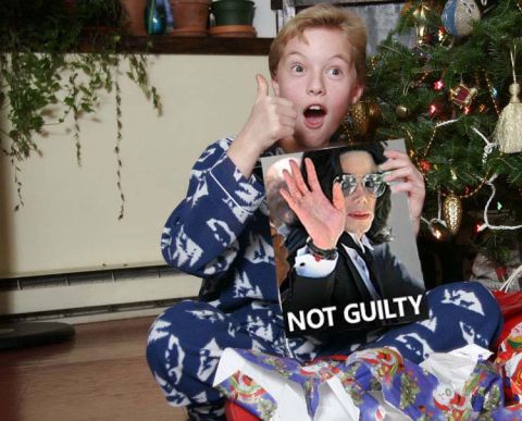 1989 Ford Bronco - A boy holds up a photo of Michael Jackson with a "NOT GUILTY" sign while sitting by a Christmas tree.