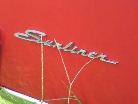 1966 Ford Ranchero - The chrome 'Sunliner' emblem is visible on the red exterior of the vehicle.