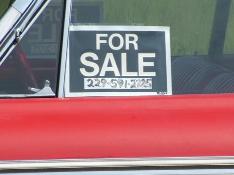 1966 Ford Ranchero - A red vehicle displays a "FOR SALE" sign with a phone number on its side window.