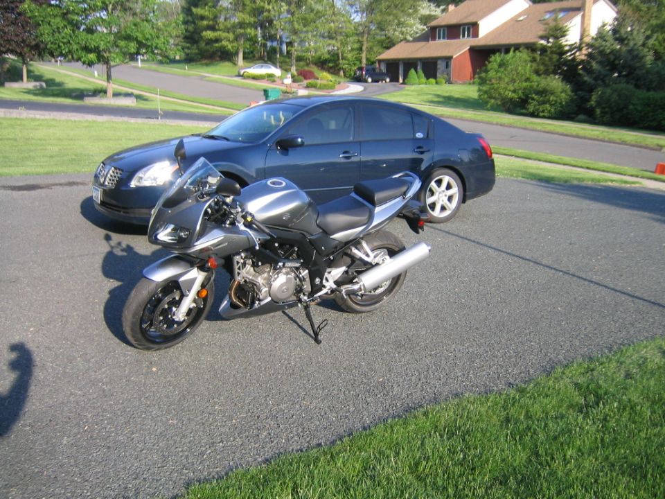 Gray Suzuki SV1000S half-faired sportbike parked on a suburban driveway