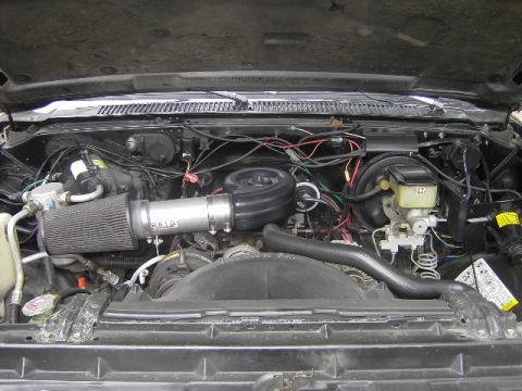 1990 Chevrolet Suburban - The engine bay shows an aftermarket air intake system installed on the vehicle.