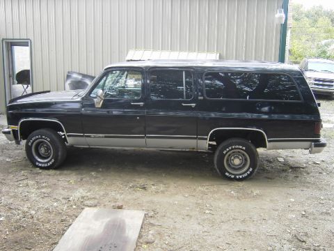 1990 Chevrolet Suburban - This 1990 Chevrolet Suburban is seen from the side, chrome trim and Dayton tires.