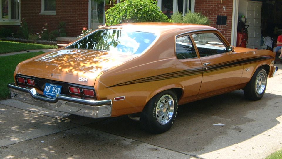 Copper Chevrolet Nova SS coupe, rear 3/4 view, on a driveway