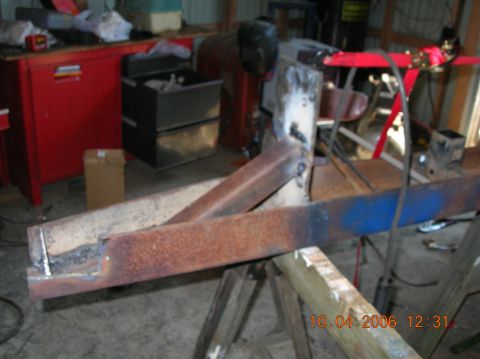 1991 Ford F-150 - Workshop scene with rusted metal parts on sawhorses, possibly under repair.
