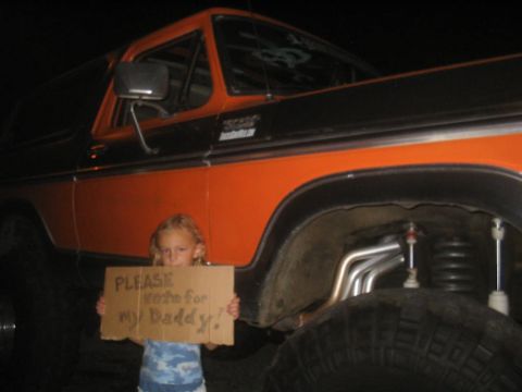 1979 Ford Bronco - A young girl stands in front of a lifted 1978 Ford Bronco holding a sign asking for votes for her dad.
