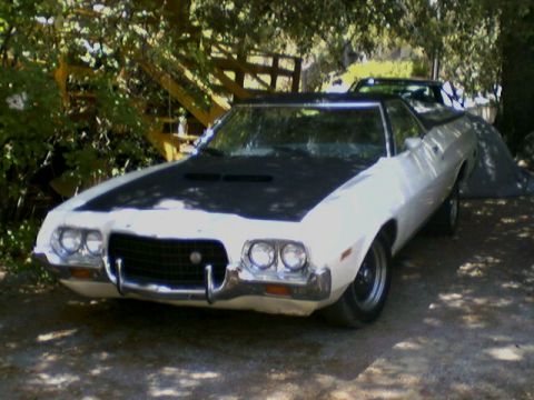 1972 Ford Ranchero - A 1972 Ford Ranchero is parked outdoors, partially shaded by trees, with another vehicle visible behind it.