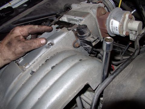1990 Lincoln Town Car - After pulling the engine I.D. plate with torx screws, crack loose the 6 upper plenum bolts. I'm pointing to the middle two and the socket e…