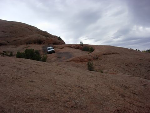 1993 Ford Bronco - Off-roading adventure on a , rocky terrain with a white SUV.