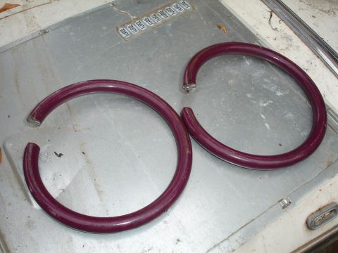 1993 Ford Taurus - Two purple coil springs, one with a broken end, are shown on a metal surface.
