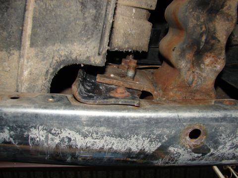 1996 Ford Bronco - Close-up view of a rusty tow hook mounting bracket, showing bolts and structural components.