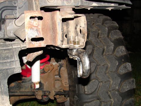 1996 Ford Bronco - Detail shot of tow hook, suspension, and tire, likely from an off-road vehicle.