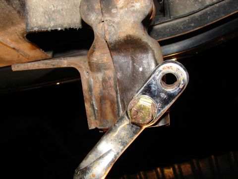 1996 Ford Bronco - This photo shows a close-up view of a vehicle's tow hook bracket, which appears to be rusted and has a shiny bolt attached.