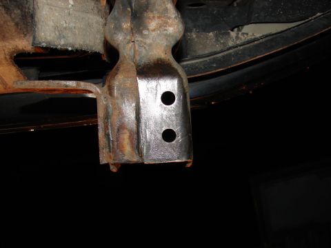 1996 Ford Bronco - Close-up of a rusted tow hook bracket, likely from the underside of a vehicle.