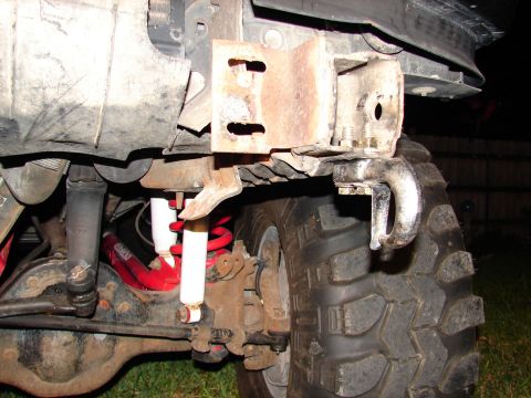 1996 Ford Bronco - Close-up of a vehicle's tow hook and suspension system, showing heavy-duty components.