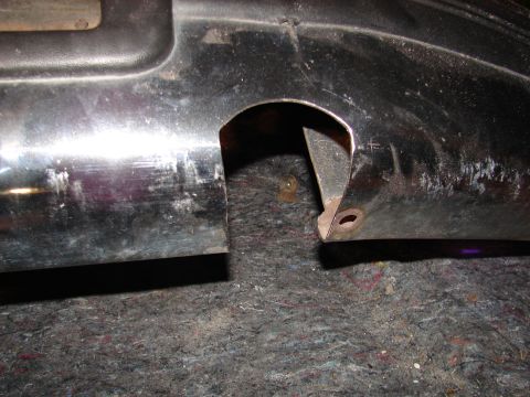 1996 Ford Bronco - Detail of a vehicle's plastic trim piece, showing a cut-out and mounting points.
