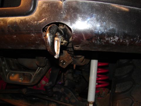 1996 Ford Bronco - Close-up view of a vehicle's undercarriage, showing a tow hook and suspension system.