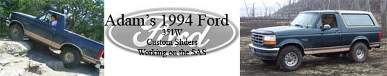 Dark green Ford Bronco with tan trim driving over rocks