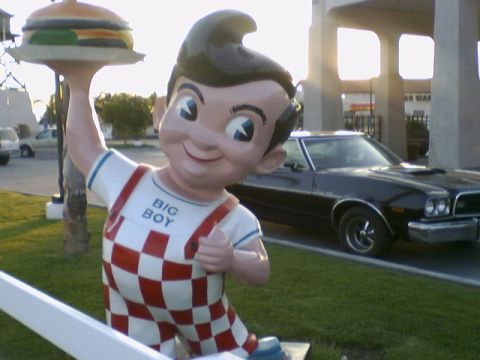1973 Ford Ranchero - A Big Boy statue stands in front of a black 1972 Ford Gran Torino Sport coupe.