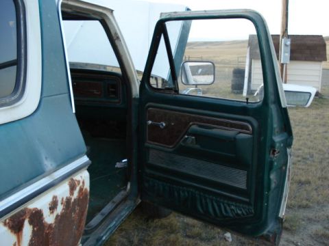 1979 Ford Bronco - Interior view of a 1979 Ford Bronco, focusing on the door panel and dashboard details.