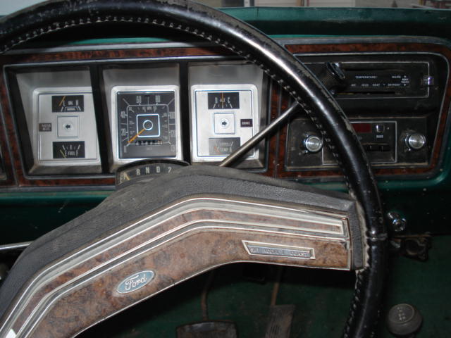 1979 Ford Bronco dashboard with wood grain trim, showing gauges and radio