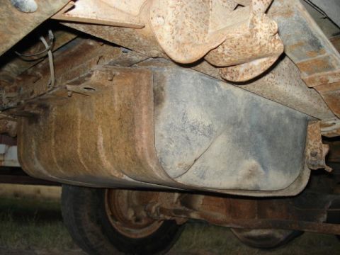 1979 Ford Bronco - Undercarriage view of a vehicle's fuel tank and suspension components.