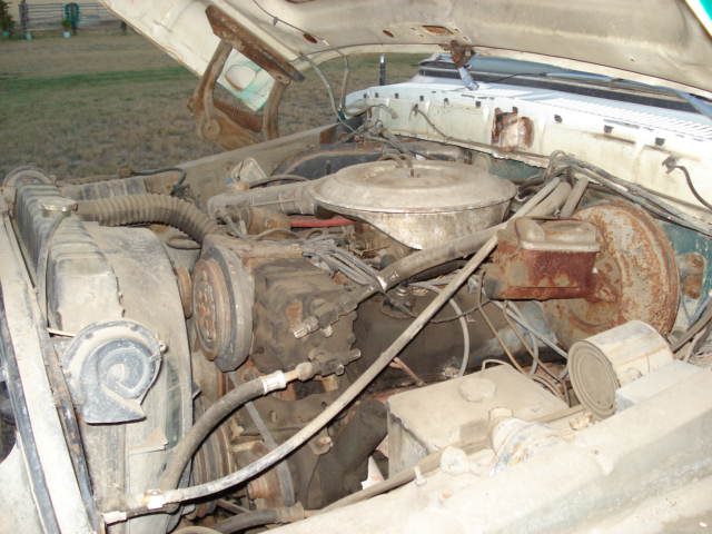 engine bay with radiator, hoses, and brake booster
