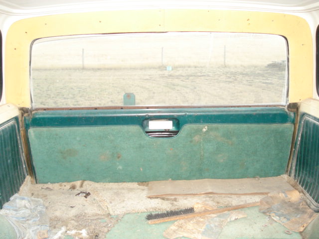 1979 Ford Bronco interior rear panel with green carpet and a large window
