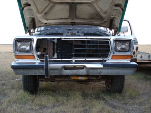 1979 Ford Bronco - The front grille and headlights of a 1979 Ford Bronco are shown with the hood raised.